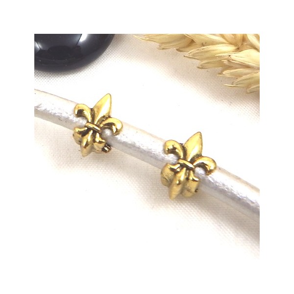 2 perles europeennes fleur de lys dorees pour cuir 5 mm